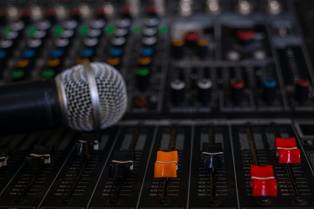 Microphone and audio sound mixer analog at the sound control room